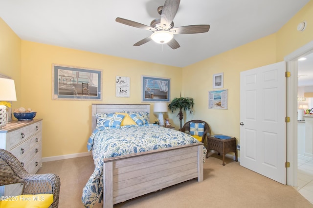 bedroom featuring light carpet, ceiling fan, and baseboards