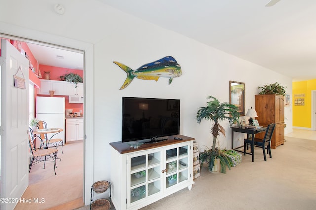 living area featuring light carpet