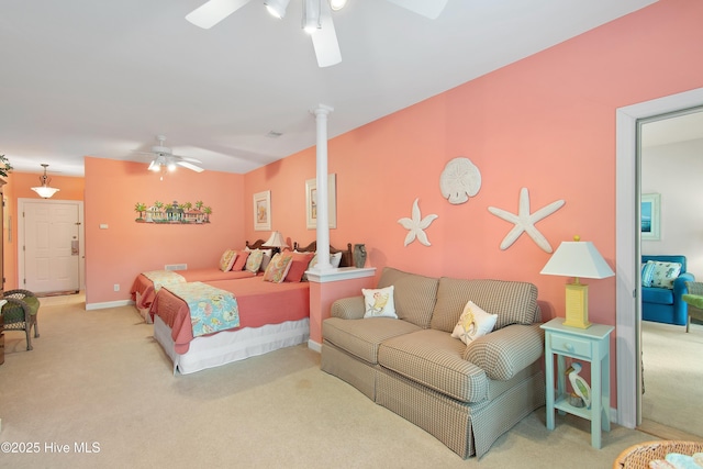 carpeted bedroom with baseboards, ceiling fan, and ornate columns