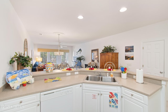 kitchen featuring light countertops, open floor plan, white cabinetry, a sink, and dishwasher