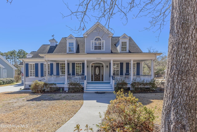 view of front of house with a shingled roof and covered porch