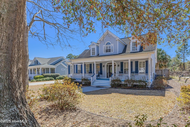 new england style home with covered porch