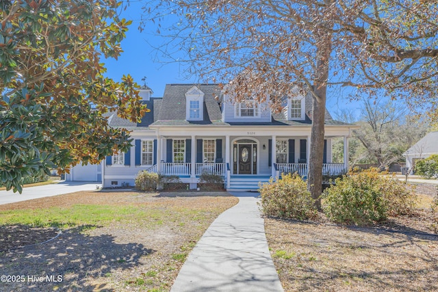 cape cod home with covered porch and a shingled roof