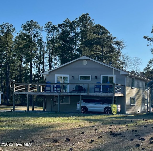 back of property with a yard and a wooden deck