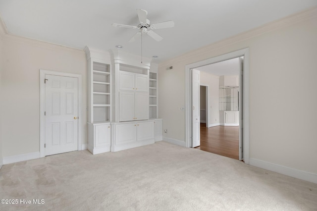 unfurnished bedroom featuring light carpet, crown molding, visible vents, and baseboards