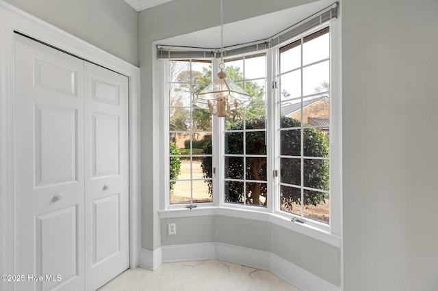 doorway with marble finish floor and baseboards