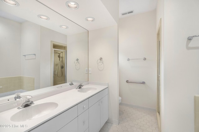 full bath featuring a stall shower, visible vents, and a sink