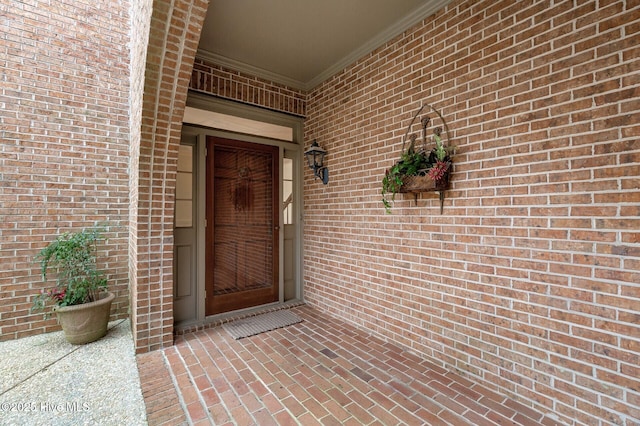 entrance to property with brick siding