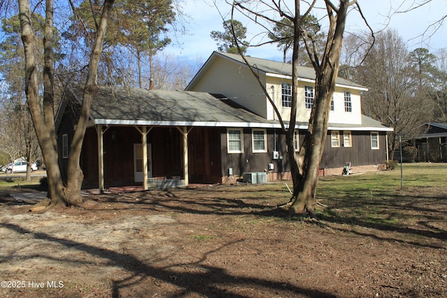 rear view of house with a porch, crawl space, a yard, and central AC unit