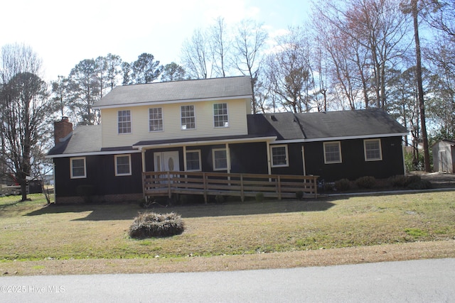 view of front of house with a chimney and a front yard