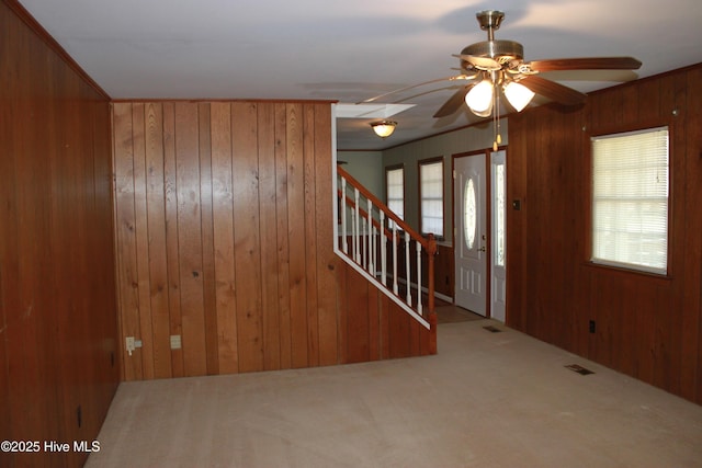 interior space with wood walls, stairs, and visible vents