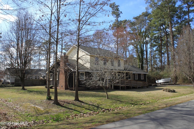 view of side of property with a yard