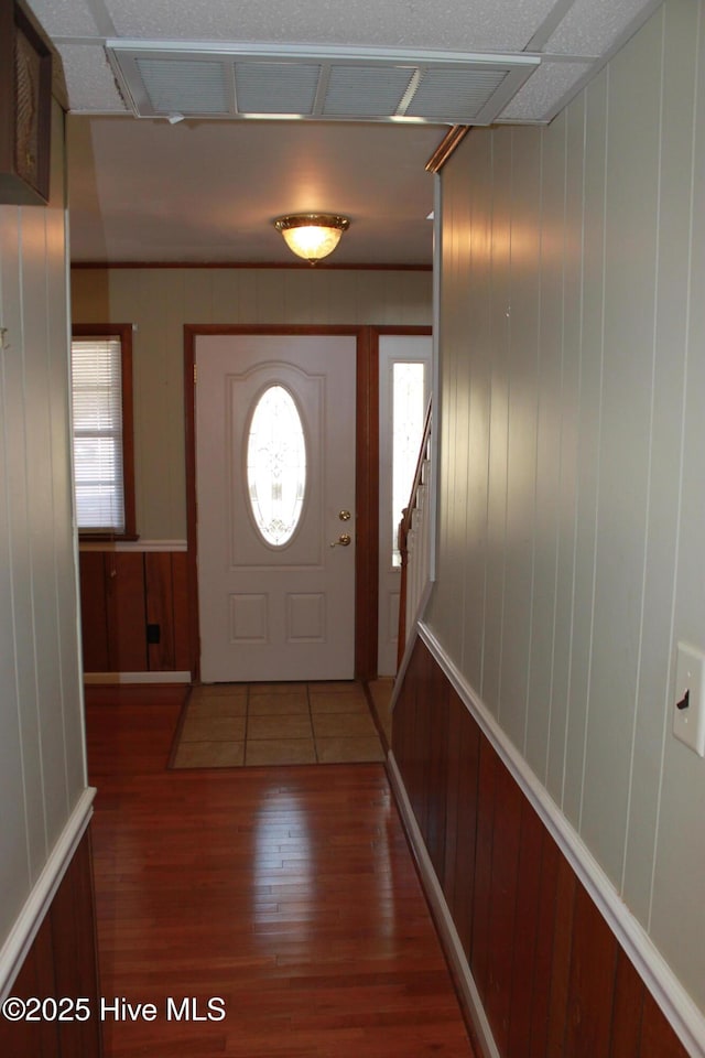 foyer with stairs, plenty of natural light, and wood finished floors