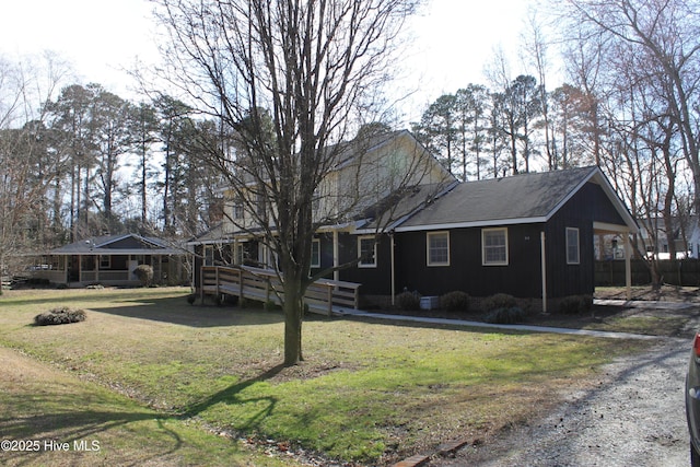 view of front of home featuring a deck and a front yard