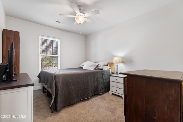 bedroom with visible vents, light carpet, and ceiling fan