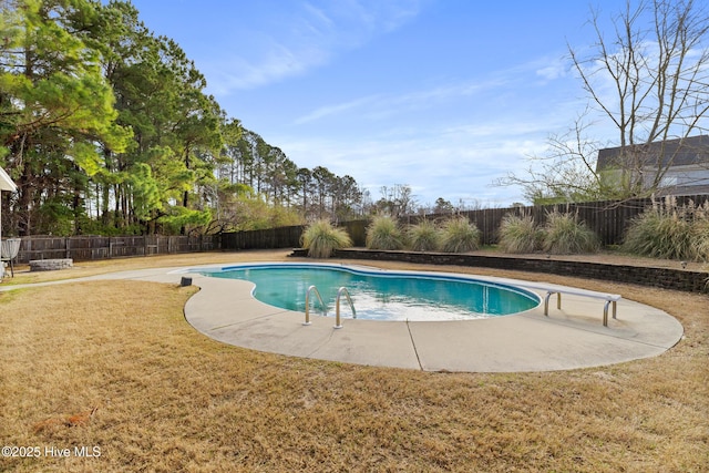 view of pool with a fenced in pool, a lawn, a fenced backyard, a patio area, and a diving board