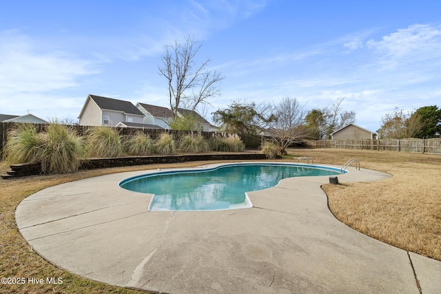 view of swimming pool featuring a fenced in pool, a patio, a lawn, and a fenced backyard