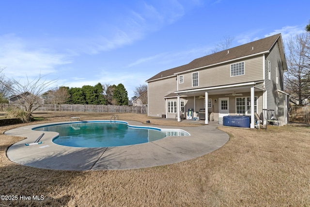 view of swimming pool featuring a patio, a fenced backyard, a diving board, a fenced in pool, and a hot tub