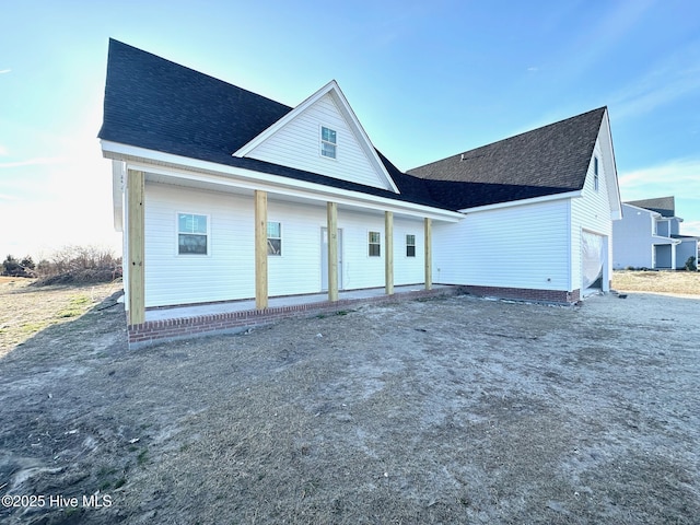 exterior space featuring a shingled roof