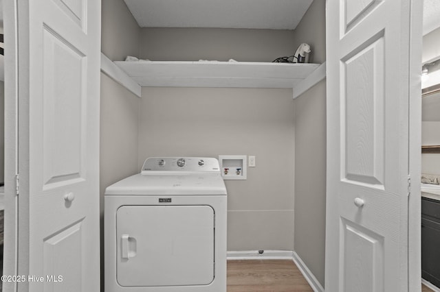 laundry room with laundry area, washer / clothes dryer, wood finished floors, and baseboards