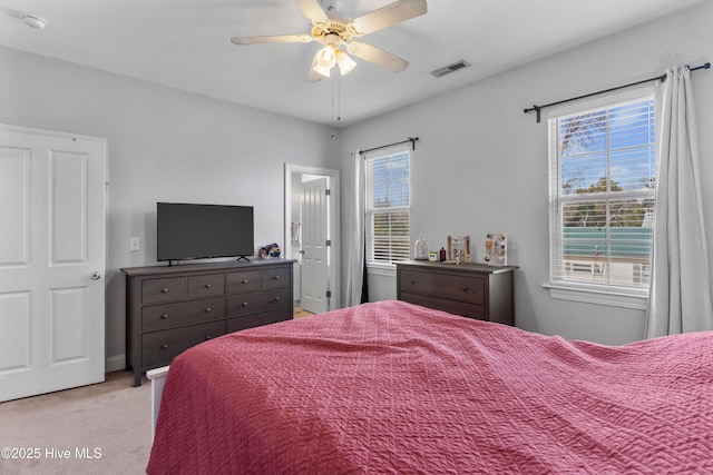 bedroom with a ceiling fan, visible vents, and carpet flooring