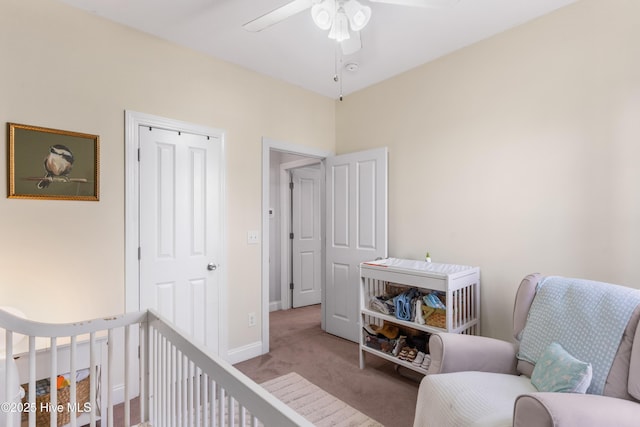 carpeted bedroom with a closet, ceiling fan, and baseboards