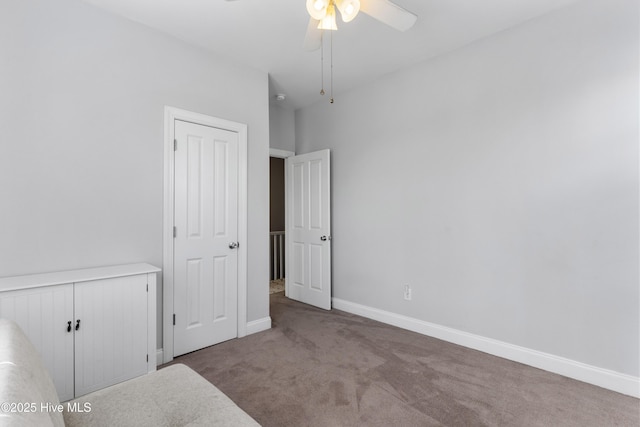 unfurnished bedroom featuring carpet, a ceiling fan, and baseboards