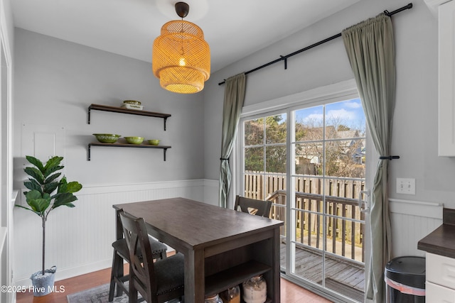 dining room with a wainscoted wall and wood finished floors