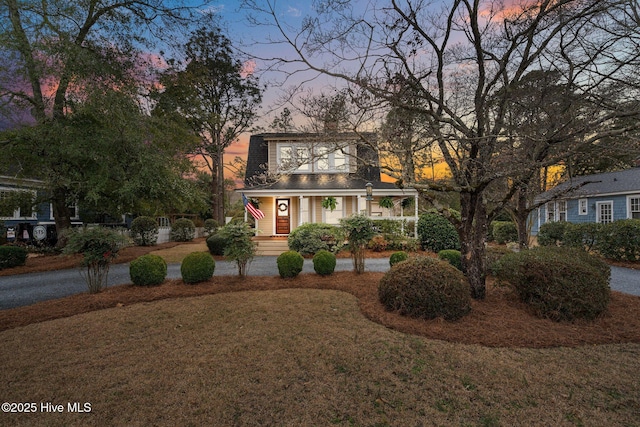 view of front of property featuring a front yard and a chimney