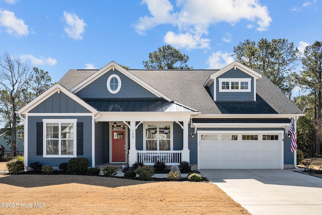 view of front of house with a porch, a garage, driveway, and roof with shingles