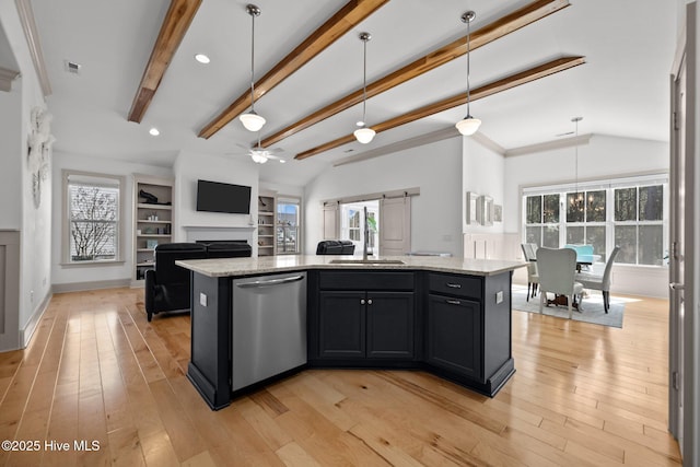 kitchen with vaulted ceiling with beams, open floor plan, light wood-style flooring, a ceiling fan, and stainless steel dishwasher