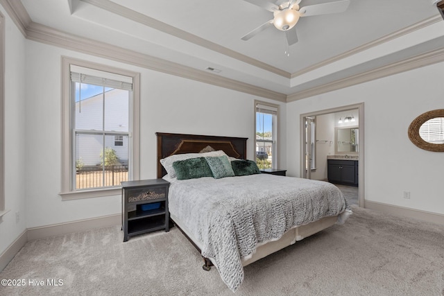 bedroom with multiple windows, crown molding, a raised ceiling, and carpet floors