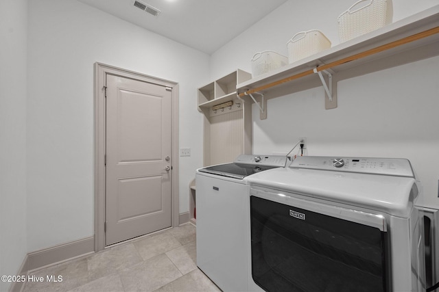 laundry area with visible vents, washer and dryer, laundry area, and baseboards