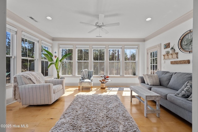 sunroom with visible vents and a ceiling fan