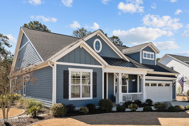 view of front of property with board and batten siding, a shingled roof, a porch, concrete driveway, and an attached garage