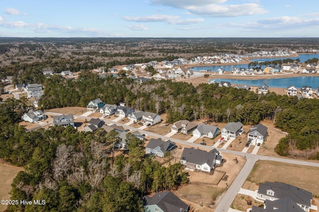 birds eye view of property with a residential view and a water view