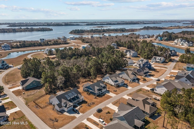 drone / aerial view featuring a water view and a residential view