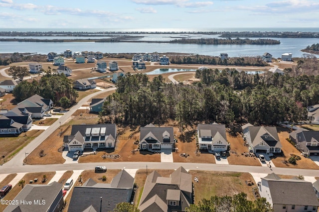 birds eye view of property with a residential view and a water view