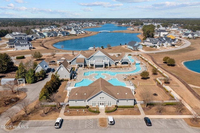 drone / aerial view with a residential view and a water view