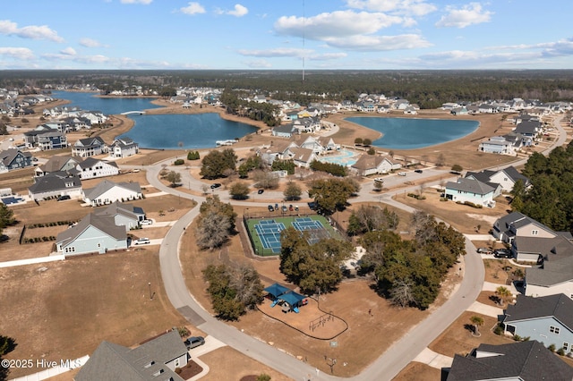 drone / aerial view with a residential view and a water view