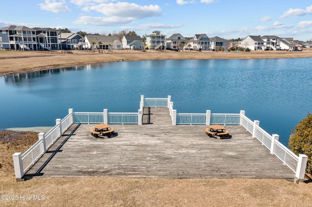 dock area with a residential view and a water view