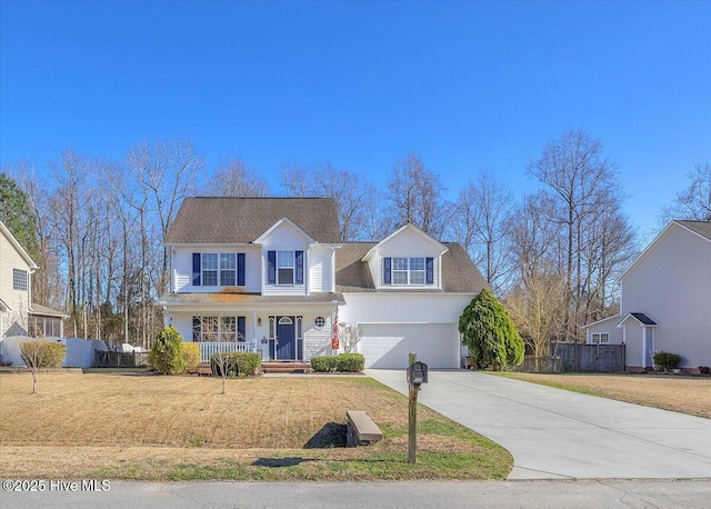 traditional home featuring a front yard, covered porch, driveway, and fence