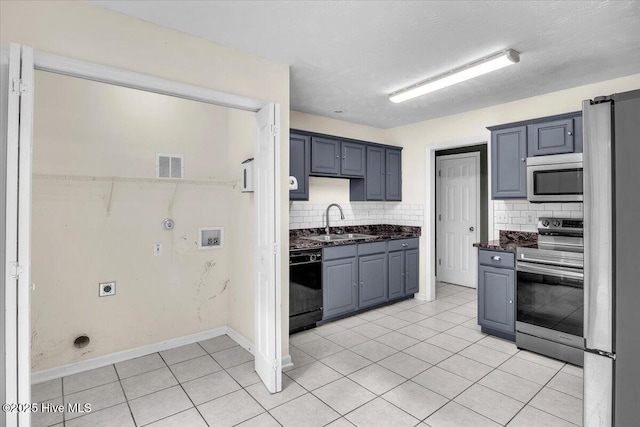 148 Mendover Dr, Jacksonville, NC 28546 - kitchen with stainless steel appliances, a sink, tasteful backsplash, light tile patterned flooring, and baseboards