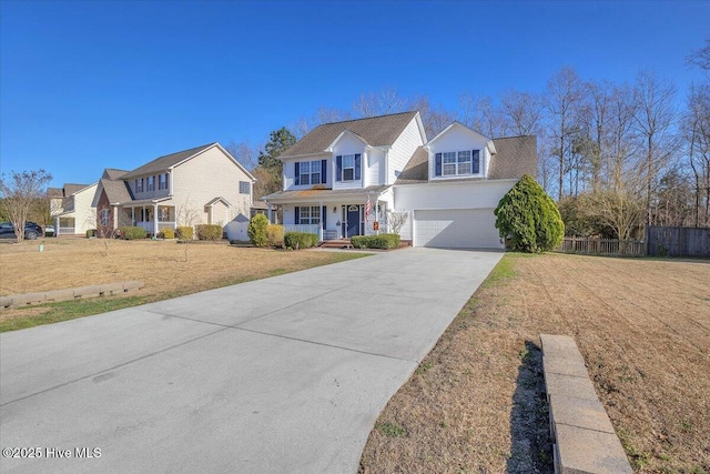 view of front of property featuring concrete driveway, a front yard, and fence