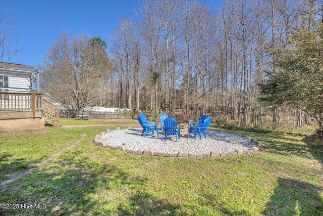 148 Mendover Dr, Jacksonville, NC 28546 - view of green lawn with a fire pit, a patio area, and a wooden deck