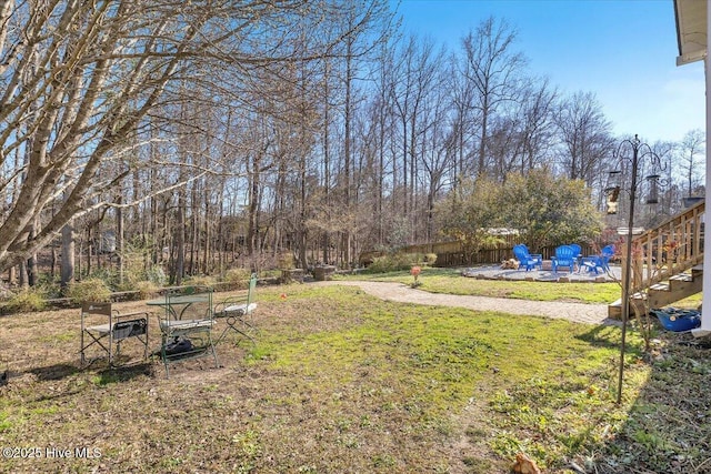 148 Mendover Dr, Jacksonville, NC 28546 - view of green lawn featuring a fire pit, a patio, and stairs