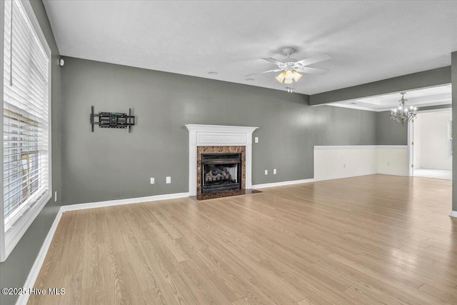 148 Mendover Dr, Jacksonville, NC 28546 - unfurnished living room with a ceiling fan, plenty of natural light, light wood-style floors, and a fireplace