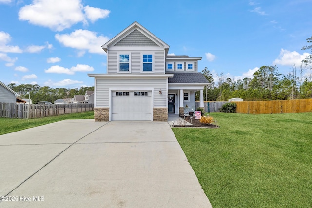 craftsman house with a garage, fence, driveway, stone siding, and a front lawn