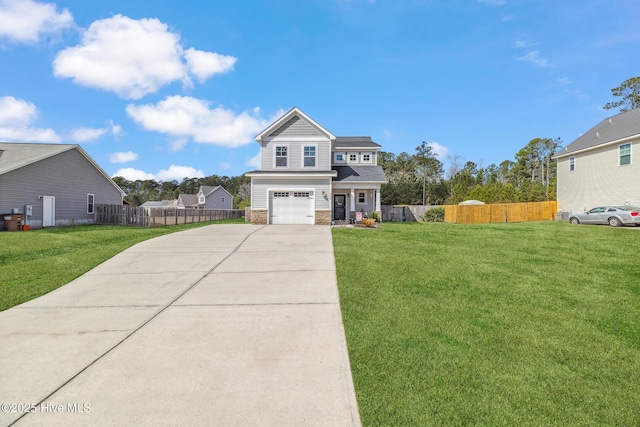 view of front of home with an attached garage, fence, concrete driveway, and a front yard