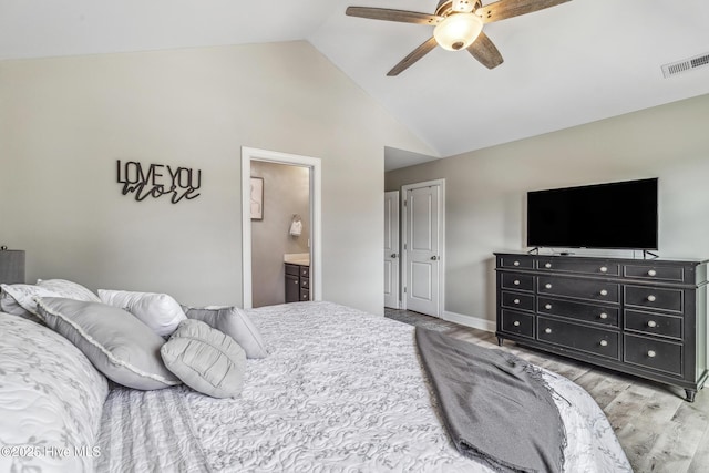 bedroom featuring lofted ceiling, ceiling fan, connected bathroom, visible vents, and light wood finished floors